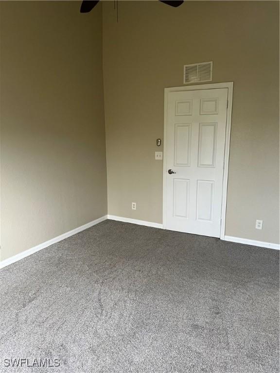 carpeted empty room with ceiling fan