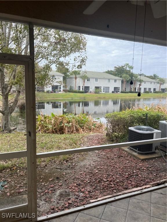 view of yard with cooling unit and a water view