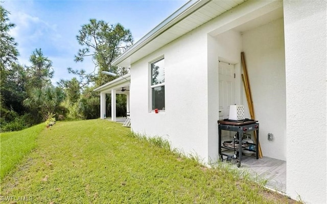 view of yard with ceiling fan