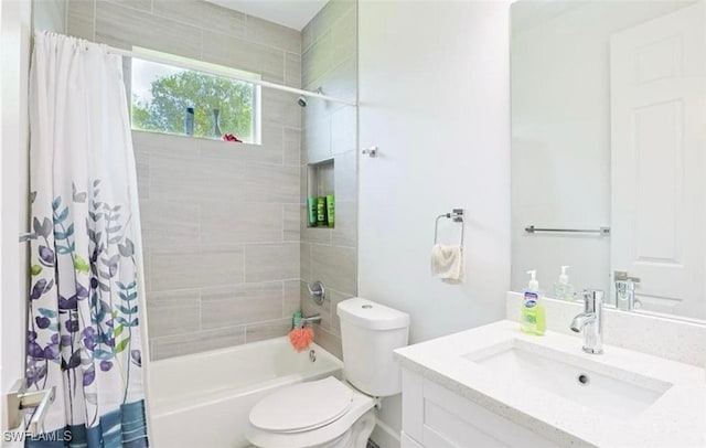 full bathroom with shower / bathtub combination with curtain, vanity, and toilet