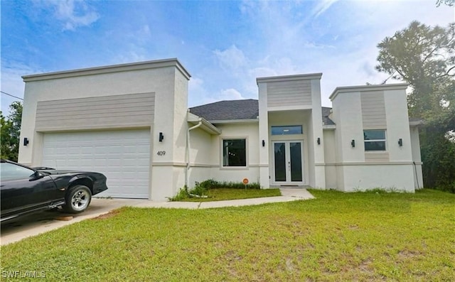 view of front of house with a front lawn, a garage, and french doors