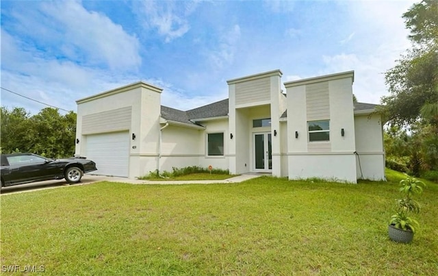 view of front of property featuring a front lawn and a garage