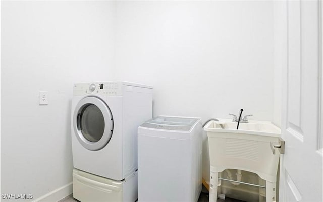 washroom featuring washer and clothes dryer and sink