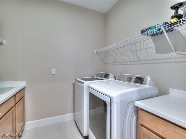 washroom with washer and clothes dryer and light tile patterned flooring