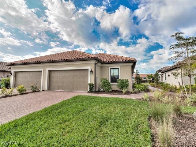 mediterranean / spanish house featuring a front lawn and a garage