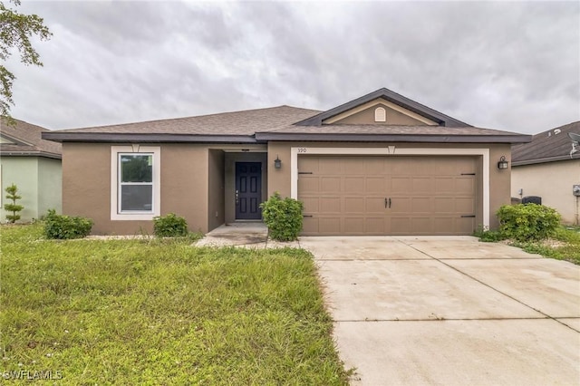 ranch-style house with a garage and a front lawn