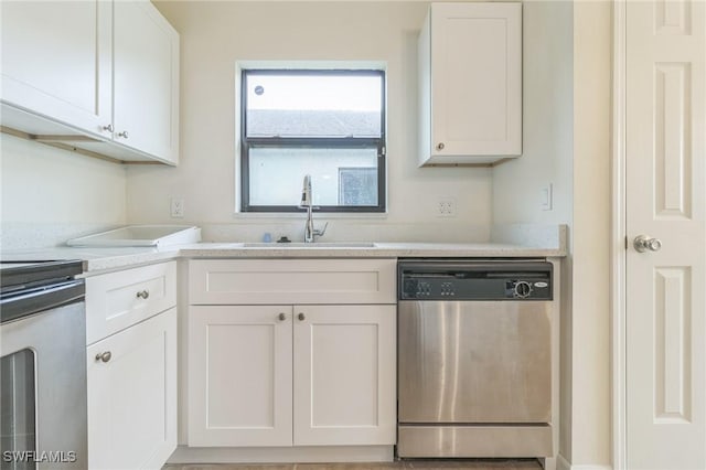 kitchen with sink, stainless steel dishwasher, white cabinetry, and stove