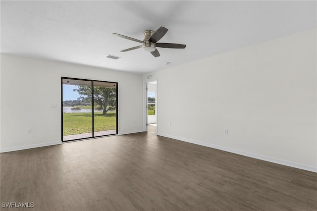 unfurnished room with ceiling fan and dark wood-type flooring