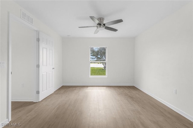 spare room featuring light hardwood / wood-style flooring and ceiling fan