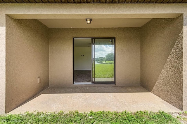 entrance to property with a patio