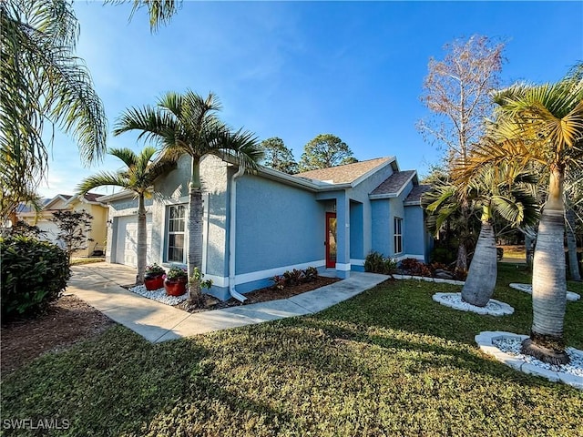 view of front facade featuring a front yard and a garage