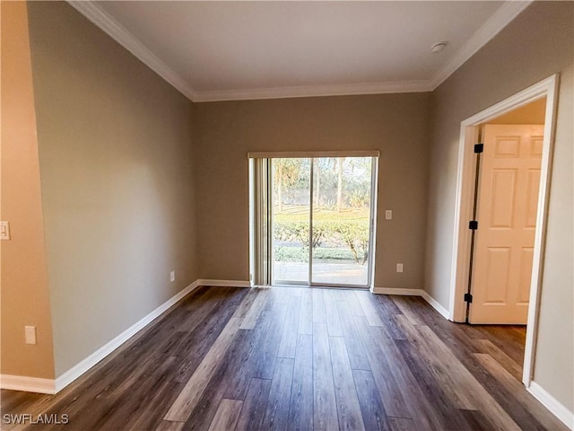 spare room featuring dark wood-type flooring and ornamental molding