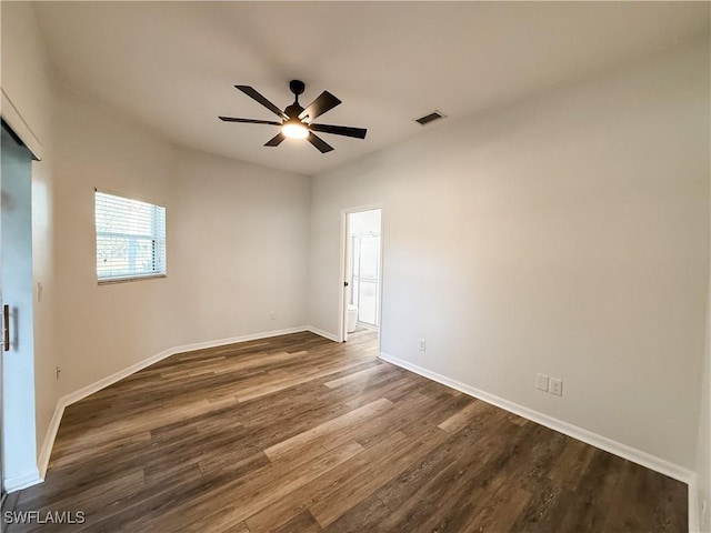 unfurnished room with ceiling fan and dark wood-type flooring