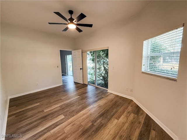 empty room featuring ceiling fan and dark hardwood / wood-style floors