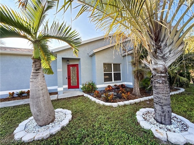 doorway to property with a yard