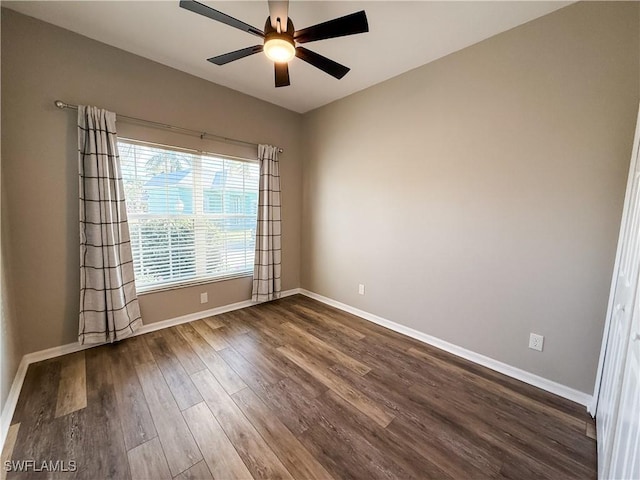 empty room with ceiling fan and dark wood-type flooring