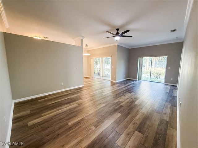 spare room with ceiling fan, dark hardwood / wood-style flooring, and ornamental molding