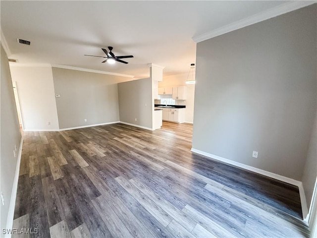 unfurnished living room featuring hardwood / wood-style floors, ceiling fan, and crown molding