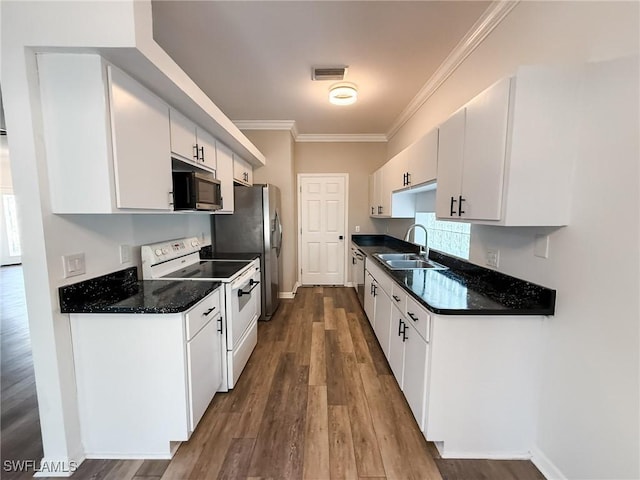 kitchen featuring electric stove, white cabinetry, and sink