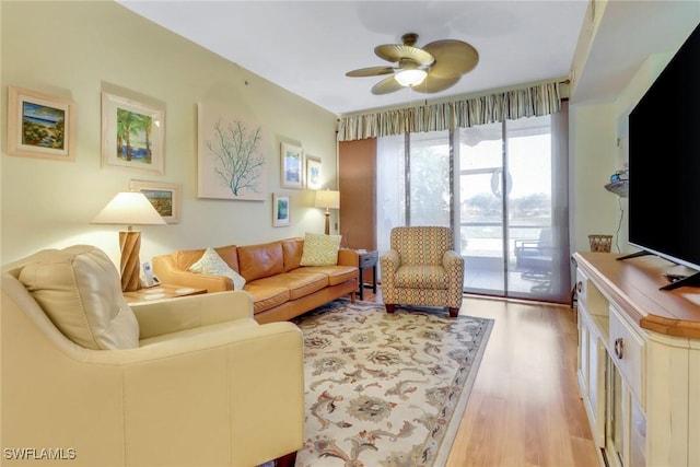 living room with ceiling fan and light hardwood / wood-style floors