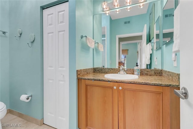 bathroom with tile patterned floors, vanity, and toilet