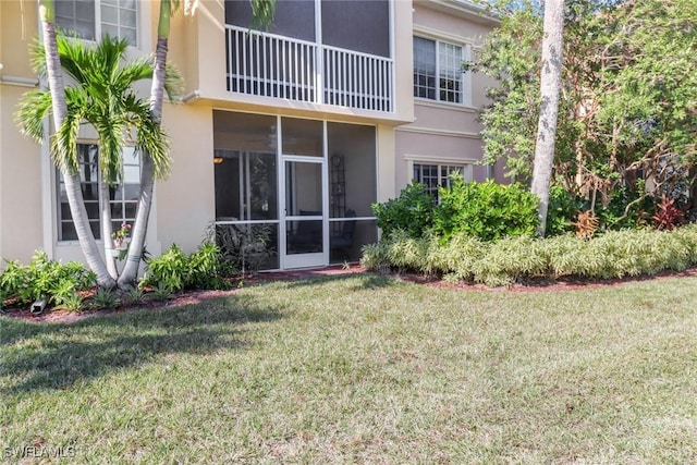 rear view of property featuring a yard