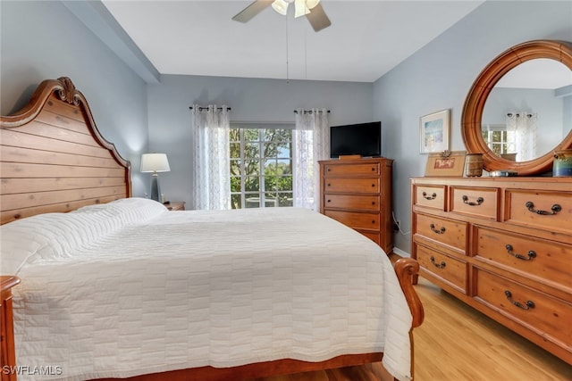 bedroom featuring access to exterior, light wood-type flooring, and ceiling fan