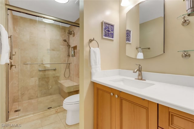 bathroom with tile patterned floors, vanity, toilet, and an enclosed shower