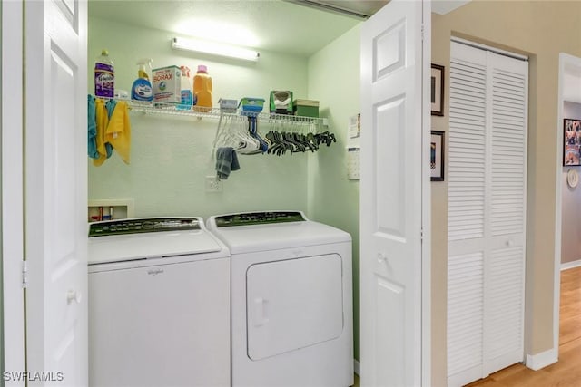 washroom featuring light hardwood / wood-style floors and separate washer and dryer