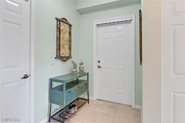 entryway with light tile patterned floors