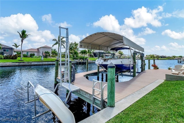 view of dock with a water view and a yard