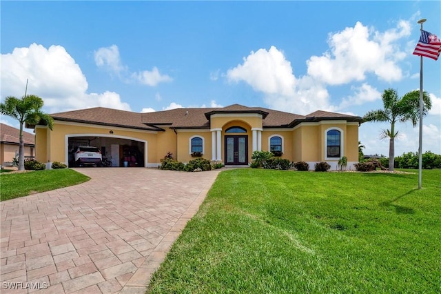 mediterranean / spanish-style home with french doors, a front lawn, and a garage