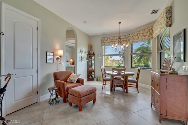 tiled dining space featuring a chandelier