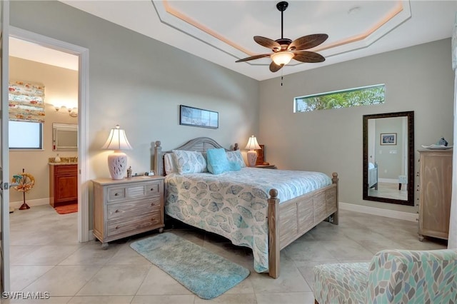 tiled bedroom featuring ceiling fan and ensuite bathroom