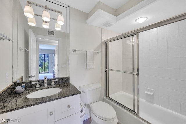 full bathroom with vanity, toilet, and enclosed tub / shower combo