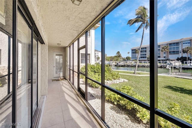 unfurnished sunroom featuring a water view and a healthy amount of sunlight