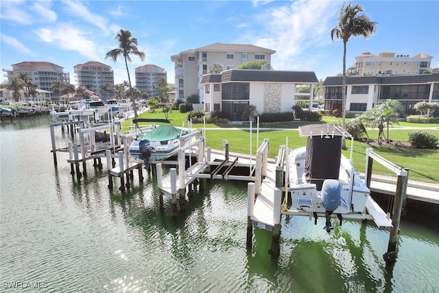 view of dock with a yard and a water view