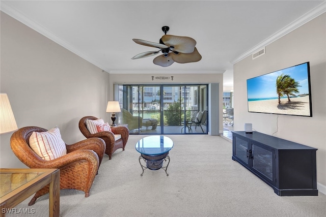 living room with ceiling fan, light colored carpet, and ornamental molding