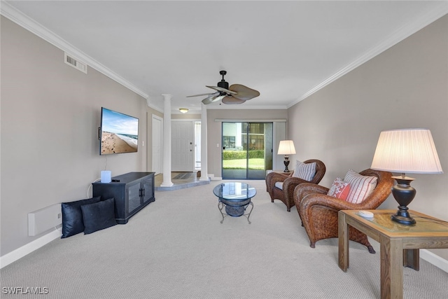 living room featuring carpet, decorative columns, ceiling fan, and crown molding