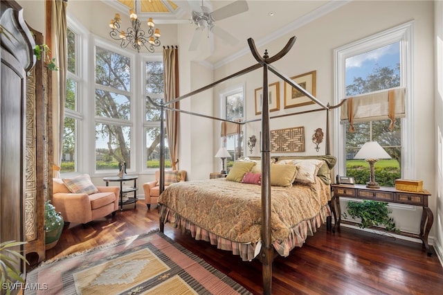 bedroom featuring crown molding, dark hardwood / wood-style flooring, ceiling fan with notable chandelier, and multiple windows