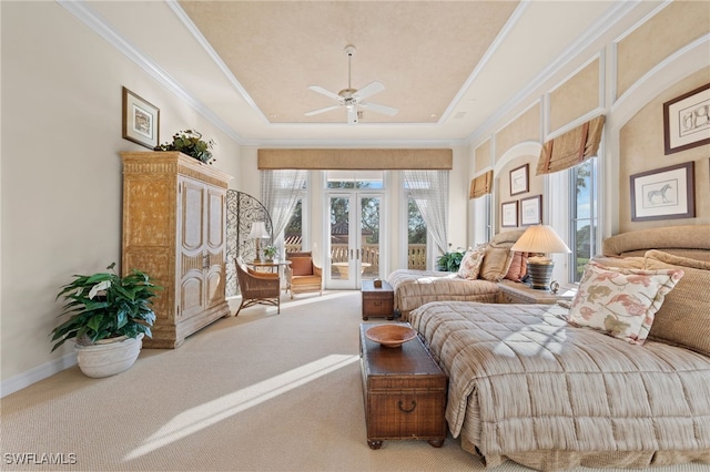 bedroom featuring french doors, access to outside, a tray ceiling, carpet flooring, and ceiling fan