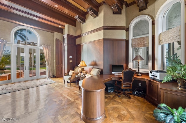 office with french doors, beamed ceiling, a towering ceiling, and light parquet floors