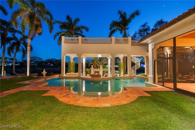 view of pool featuring a patio, exterior fireplace, and a lawn