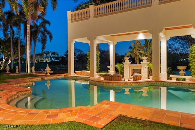 view of pool with a patio and an outdoor fireplace