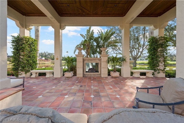 view of patio with a multi sided fireplace