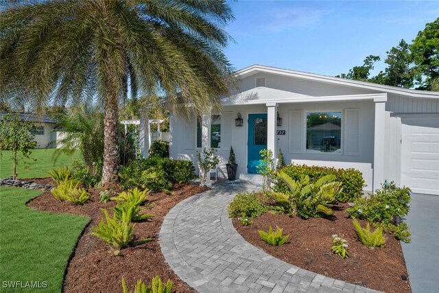 view of front of house with a garage and a front lawn