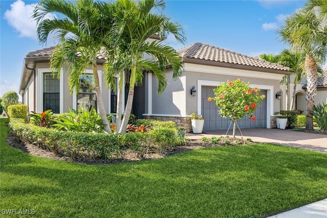 mediterranean / spanish-style home featuring a garage and a front lawn