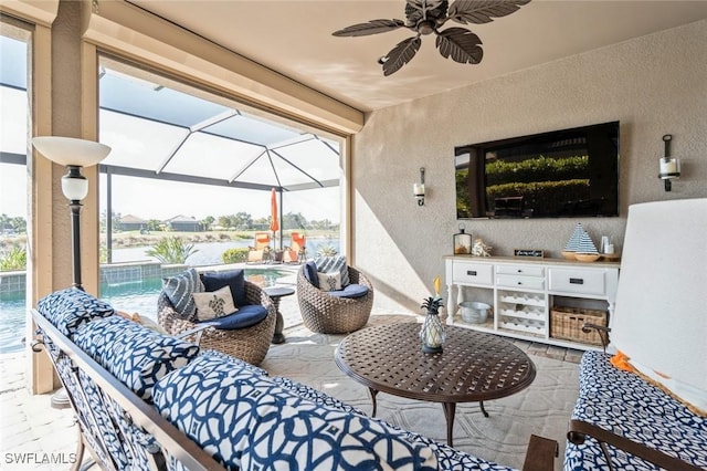 view of patio with exterior kitchen, ceiling fan, outdoor lounge area, and pool water feature