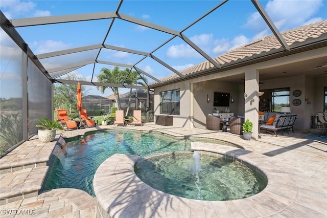 view of pool featuring an in ground hot tub, pool water feature, glass enclosure, and a patio area