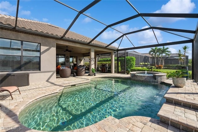 view of swimming pool with an in ground hot tub, ceiling fan, a lanai, and a patio area